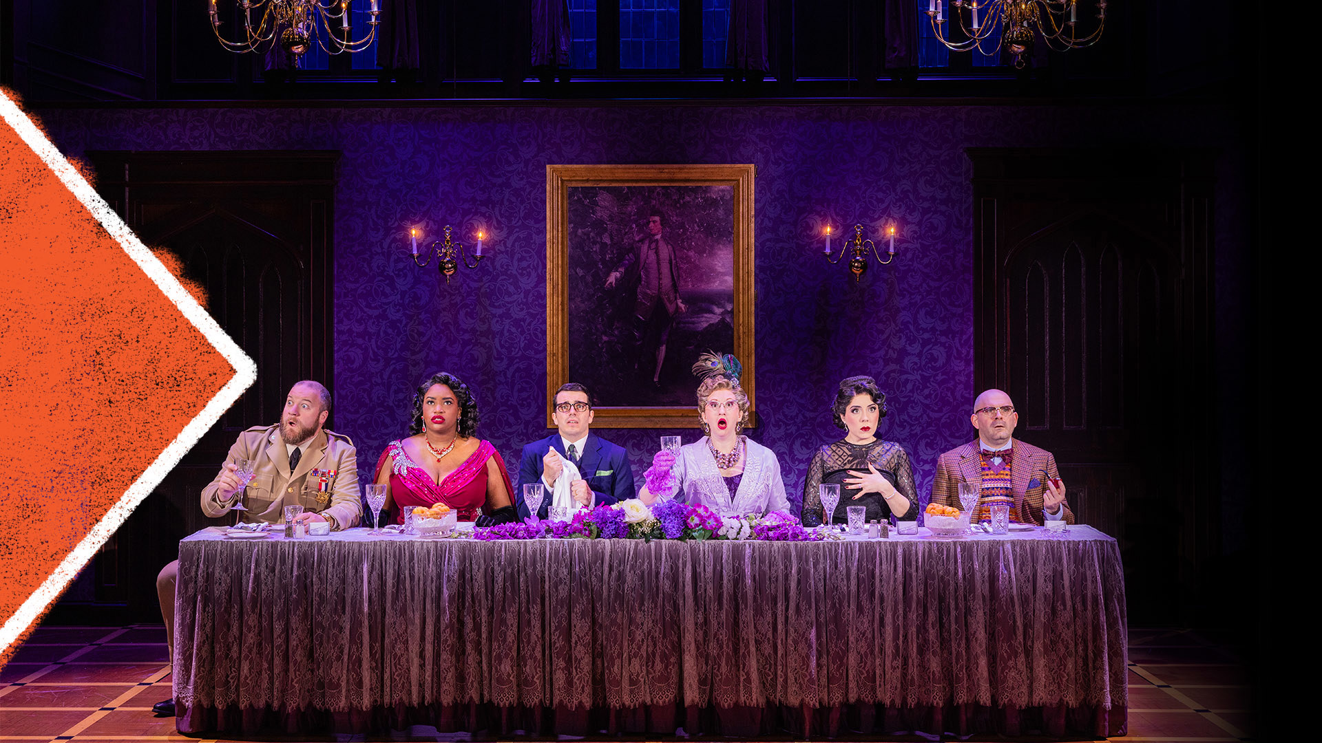 Six cast members sit a dinner table looking bewildered against a mansion backdrop.