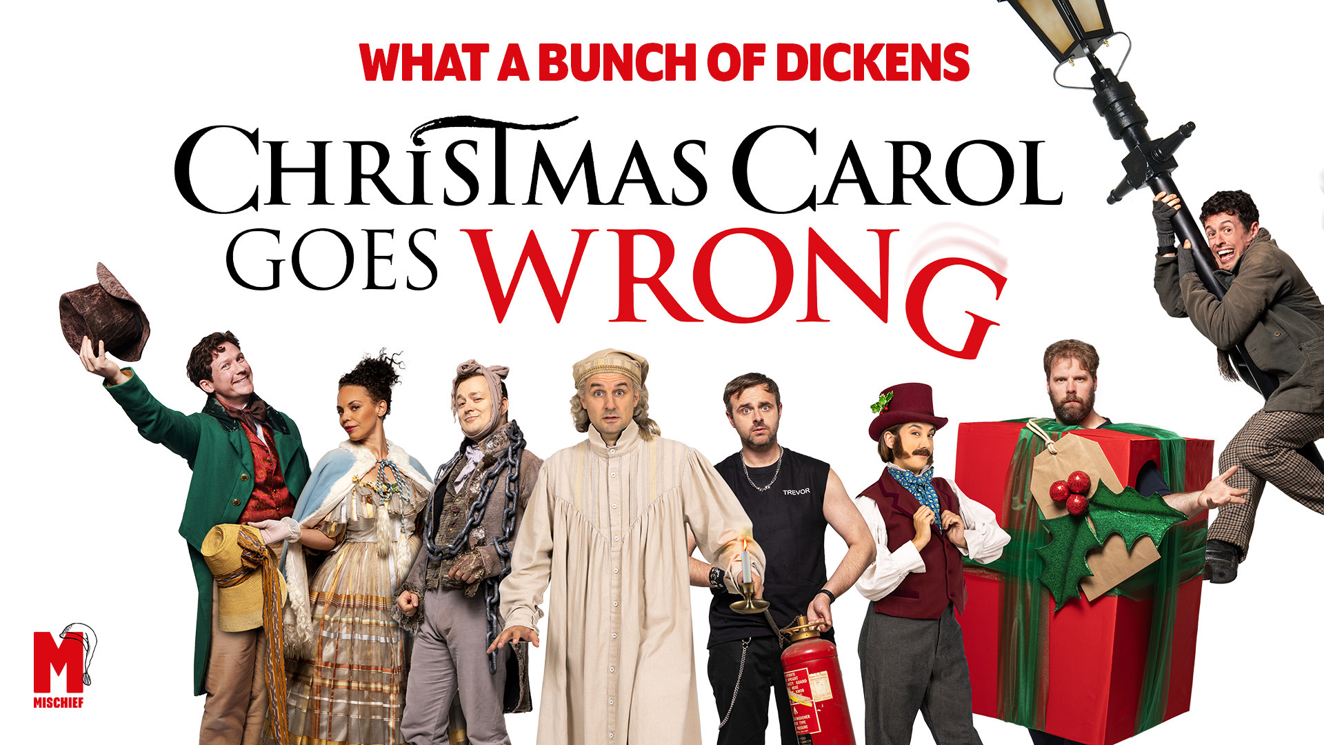 What a Bunch of Dickens. Christmas Carol Goes Wrong. Promotional artwork featuring the ensemble cast in Victorian costumes with comedic props, including a falling streetlamp and oversized gift box.